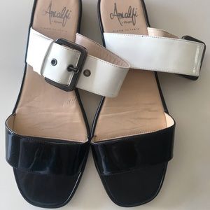 Amalfi. Flat patent leather slide on sandals, black and white with buckle